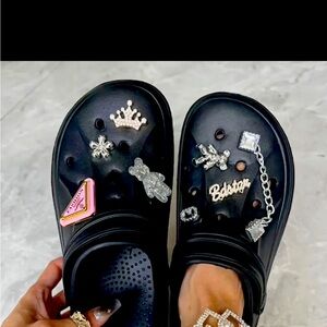 Black crocs with charms included and a mystery charm bag